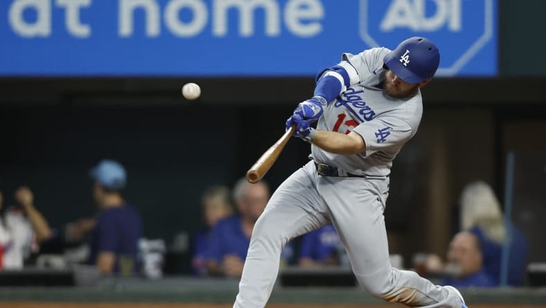 Jul 22, 2023; Arlington, Texas, USA; Los Angeles Dodgers third baseman Max Muncy (13) hits a home run against the Texas Rangers in the third inning at Globe Life Field. Mandatory Credit: Tim Heitman-USA TODAY Sports