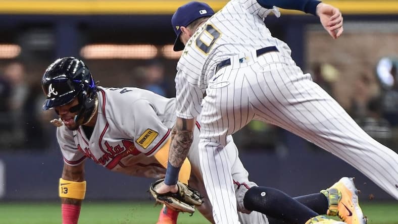 Jul 22, 2023; Milwaukee, Wisconsin, USA; Atlanta Braves right fielder Ronald Acuna (13) steals second base before the tag by Milwaukee Brewers second baseman Brice Turang (0) in the first inning at American Family Field. Mandatory Credit: Benny Sieu-USA TODAY Sports