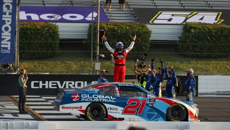 Jul 22, 2023; Long Pond, Pennsylvania, USA; NASCAR Xfinity Series driver Austin Hill (21) celebrates after winning the Explore The Pocono Mountains 225 at Pocono Raceway. Mandatory Credit: Matthew O'Haren-USA TODAY Sports