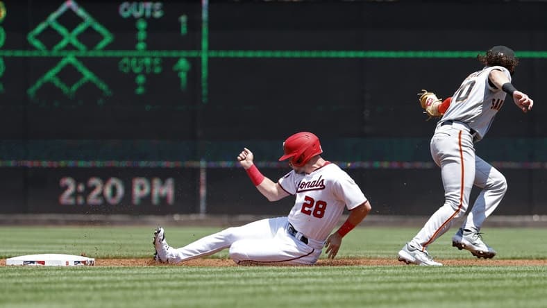 Jul 23, 2023; Washington, District of Columbia, USA; Washington Nationals right fielder Lane Thomas (28) steals second base ahead of a tag by San Francisco Giants second baseman Brett Wisely (70) during the first inning at Nationals Park. Mandatory Credit: Geoff Burke-USA TODAY Sports
