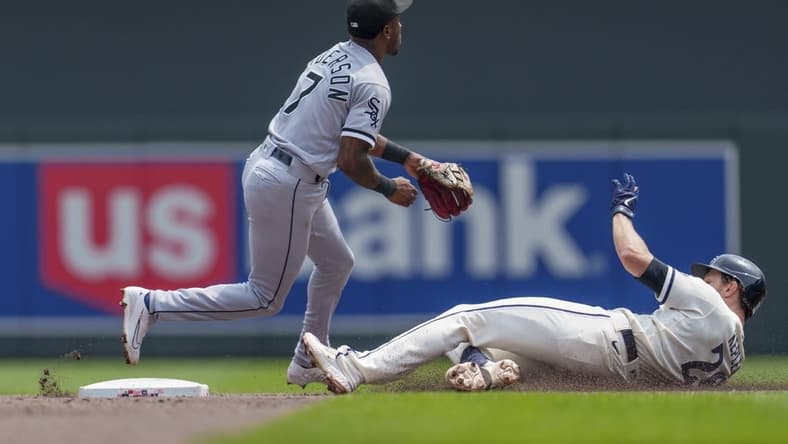 Jul 23, 2023; Minneapolis, Minnesota, USA; Minnesota Twins right fielder Max Kepler (26) doubles as Chicago White Sox shortstop Tim Anderson (7) fields the throw from right in the second inning at Target Field. Mandatory Credit: Matt Blewett-USA TODAY Sports