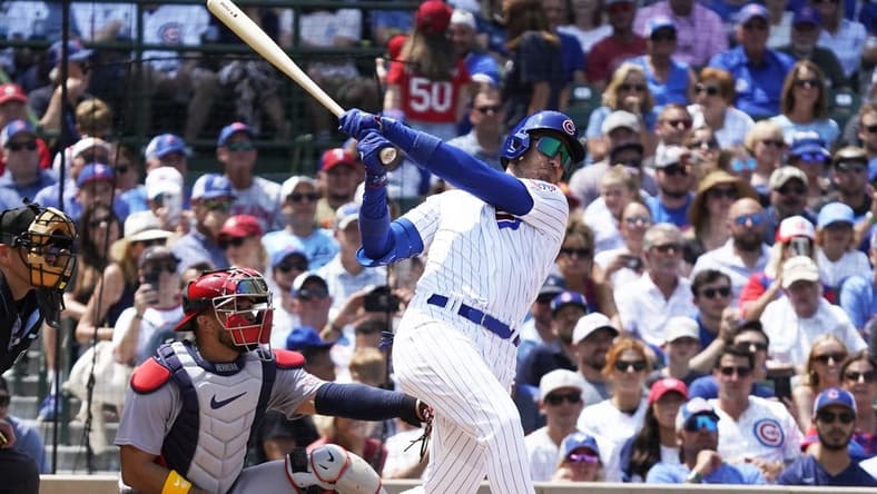 Jul 23, 2023; Chicago, Illinois, USA; Chicago Cubs center fielder Cody Bellinger (24) hits a one run sacrifice fly against the St. Louis Cardinals during the third inning at Wrigley Field. Mandatory Credit: David Banks-USA TODAY Sports