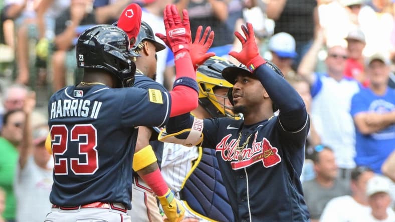 Jul 23, 2023; Milwaukee, Wisconsin, USA; Atlanta Braves second baseman Ozzie Albies (1) is greeted by center fielder Michael Harris (23) after hitting a three run home run in the eighth inning against the Milwaukee Brewers at American Family Field. Mandatory Credit: Benny Sieu-USA TODAY Sports