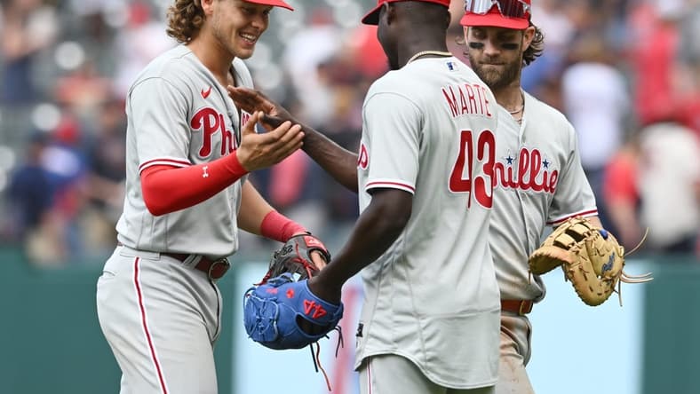 Jul 23, 2023; Cleveland, Ohio, USA; Philadelphia Phillies relief pitcher Yunior Marte (43) celebrates with third baseman Alec Bohm (28) and Bryce Harper (3) after the Phillies beat the Cleveland Guardians at Progressive Field. Mandatory Credit: Ken Blaze-USA TODAY Sports
