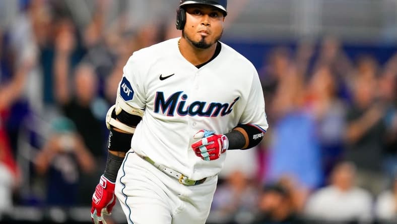 Jul 23, 2023; Miami, Florida, USA; Miami Marlins second baseman Luis Arraez (3) runs to first base after hitting the winning hit against the Colorado Rockies during the tenth inning at loanDepot Park. Mandatory Credit: Rich Storry-USA TODAY Sports