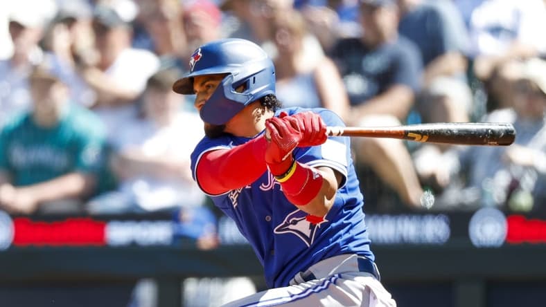 Jul 23, 2023; Seattle, Washington, USA; Toronto Blue Jays second baseman Santiago Espinal (5) hits an RBI-single against the Seattle Mariners during the seventh inning at T-Mobile Park. Mandatory Credit: Joe Nicholson-USA TODAY Sports