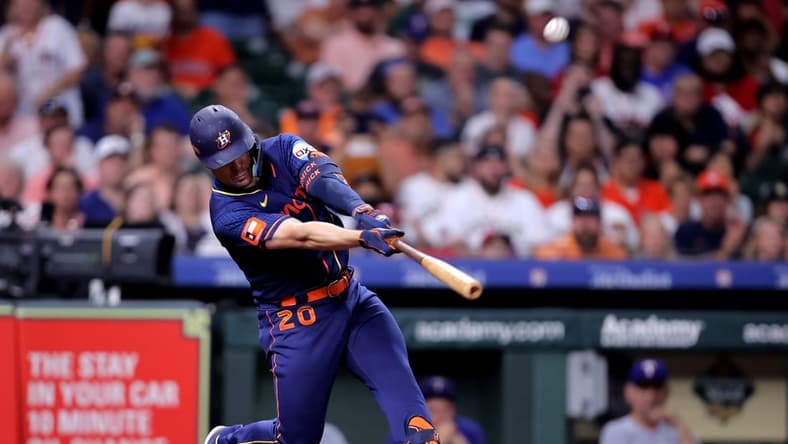 Jul 24, 2023; Houston, Texas, USA; Houston Astros left fielder Chas McCormick (20) hits a sacrifice fly for an out against the Texas Rangers during the fifth inning Minute Maid Park. Mandatory Credit: Erik Williams-USA TODAY Sports