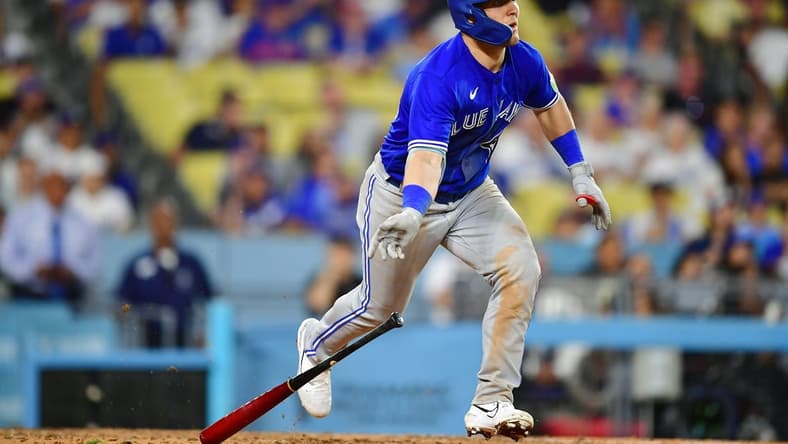 Jul 24, 2023; Los Angeles, California, USA; Toronto Blue Jays left fielder Daulton Varsho (25) hits a two run RBI double against the Los Angeles Dodgers during the eleventh inning  at Dodger Stadium. Mandatory Credit: Gary A. Vasquez-USA TODAY Sports