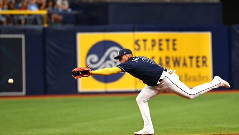 Jul 25, 2023; St. Petersburg, Florida, USA; Tampa Bay Rays third baseman Isaac Paredes (17) reaches for a line drive in the second inning against the Miami Marlins at Tropicana Field. Mandatory Credit: Jonathan Dyer-USA TODAY Sports