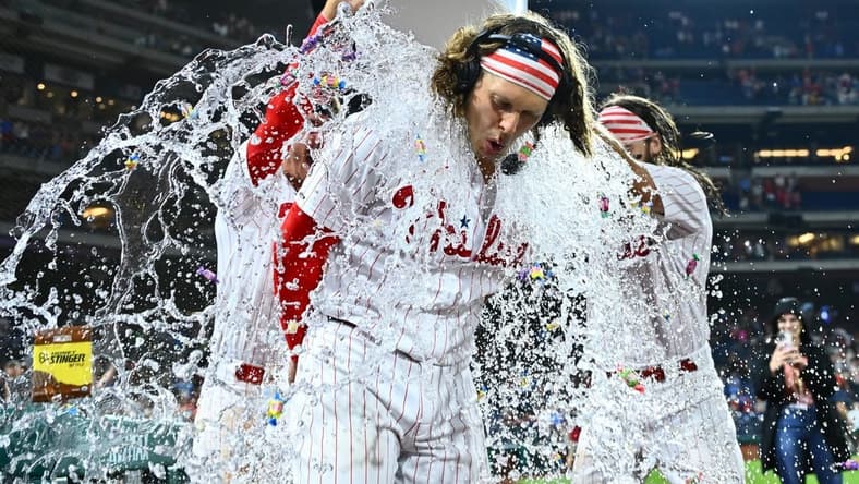Jul 25, 2023; Philadelphia, Pennsylvania, USA; Philadelphia Phillies infielder Alec Bohm (28) is doused with water after the game for hitting a game-winning RBI single against the Baltimore Orioles at Citizens Bank Park. Mandatory Credit: Kyle Ross-USA TODAY Sports