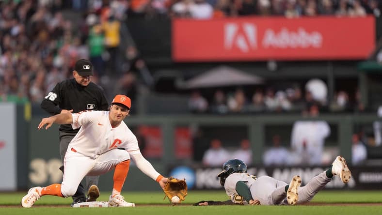 Jul 25, 2023; San Francisco, California, USA; Oakland Athletics second baseman Zack Gelof (20) slides during the sixth inning against San Francisco Giants shortstop Casey Schmitt (6) at Oracle Park. Mandatory Credit: Stan Szeto-USA TODAY Sports