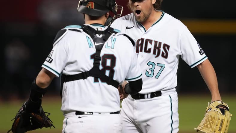Jul 25, 2023; Phoenix, Arizona, USA; Arizona Diamondbacks relief pitcher Kevin Ginkel (37) celebrates with Arizona Diamondbacks catcher Carson Kelly (18) after defeating the St. Louis Cardinals at Chase Field. Mandatory Credit: Joe Camporeale-USA TODAY Sports