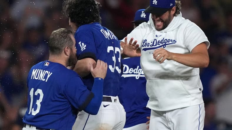 Jul 25, 2023; Los Angeles, California, USA; Los Angeles Dodgers center fielder James Outman (33) celebrates with third baseman Max Muncy (13) and pitcher Clayton Kershaw after hitting a walk-off double in the 10th inning against the Toronto Blue Jays at Dodger Stadium. Mandatory Credit: Kirby Lee-USA TODAY Sports