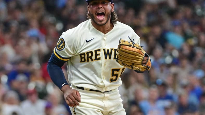 Jul 26, 2023; Milwaukee, Wisconsin, USA; Milwaukee Brewers pitcher Freddy Peralta (51) reacts after striking out Cincinnati Reds shortstop Matt McLain (9) in the sixth inning at American Family Field. Mandatory Credit: Benny Sieu-USA TODAY Sports