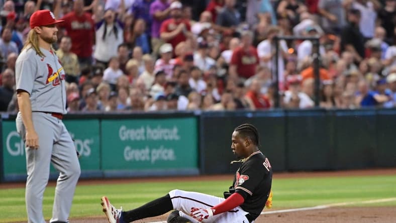 Jul 26, 2023; Phoenix, Arizona, USA; Arizona Diamondbacks shortstop Geraldo Perdomo (2) hits a triple as St. Louis Cardinals second baseman Taylor Motter (55)looks on i the first inning at Chase Field. Mandatory Credit: Matt Kartozian-USA TODAY Sports