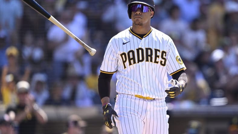 Jul 26, 2023; San Diego, California, USA; San Diego Padres left fielder Juan Soto (22) tosses his bat after a bases-loaded walk against the Pittsburgh Pirates during the ninth inning at Petco Park. Mandatory Credit: Orlando Ramirez-USA TODAY Sports