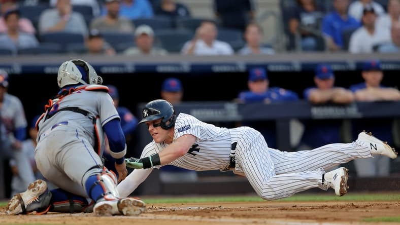 Jul 26, 2023; Bronx, New York, USA; New York Yankees center fielder Harrison Bader (22) scores a run against New York Mets catcher Francisco Alvarez (4) on a sacrifice fly by Yankees left fielder Isiah Kiner-Falefa (not pictured) during the second inning at Yankee Stadium. Mandatory Credit: Brad Penner-USA TODAY Sports