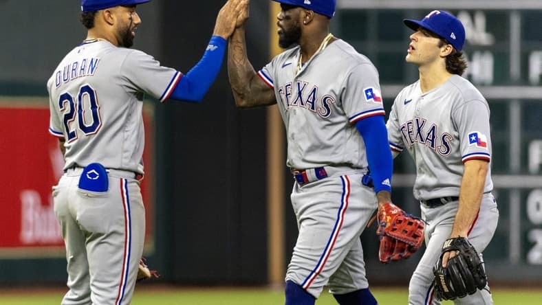 Jul 26, 2023; Houston, Texas, USA; Texas Rangers right fielder Adolis Garcia (53) and shortstop Ezequiel Duran (20) celebrate the win against the Houston Astros in the ninth inning at Minute Maid Park. Mandatory Credit: Thomas Shea-USA TODAY Sports