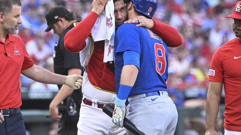 Jul 27, 2023; St. Louis, Missouri, USA; St. Louis Cardinals catcher Willson Contreras (40) hugs Chicago Cubs left fielder Ian Happ (8) after being hit by Happs follow through in the first inning at Busch Stadium. Mandatory Credit: Joe Puetz-USA TODAY Sports