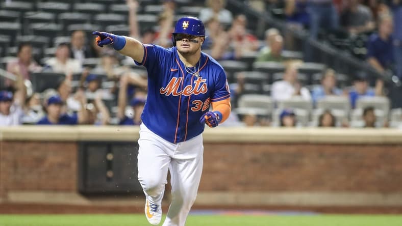 Jul 27, 2023; New York City, New York, USA; New York Mets designated hitter Daniel Vogelbach (32) points to the dugout after hitting a game-tying RBI single in the eighth inning against the Washington Nationals at Citi Field. Mandatory Credit: Wendell Cruz-USA TODAY Sports