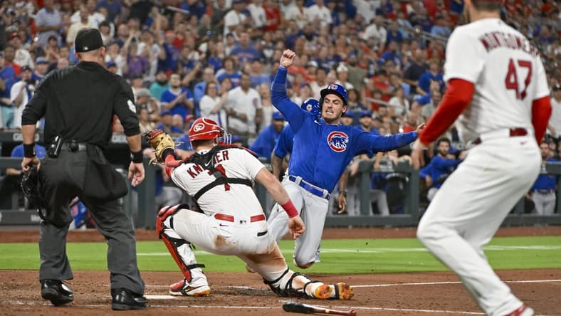 Jul 28, 2023; St. Louis, Missouri, USA;  Chicago Cubs center fielder Cody Bellinger (24) is tagged out at home plate by St. Louis Cardinals catcher Andrew Knizner (7) during the sixth inning at Busch Stadium. Mandatory Credit: Jeff Curry-USA TODAY Sports