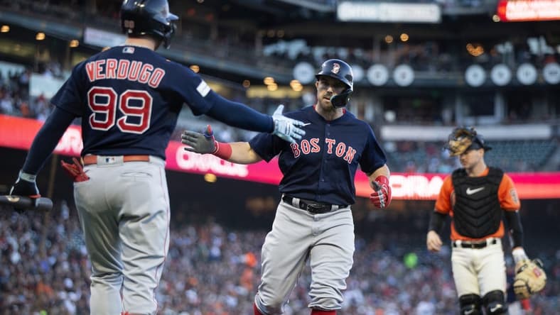 Jul 28, 2023; San Francisco, California, USA; Boston Red Sox center fielder Adam Duvall (right) gets a congratulatory handshake from teammate Alex Verdugo (99) as he scores on a double by Tristan Casas during the second inning against the San Francisco Giants at Oracle Park. Mandatory Credit: D. Ross Cameron-USA TODAY Sports