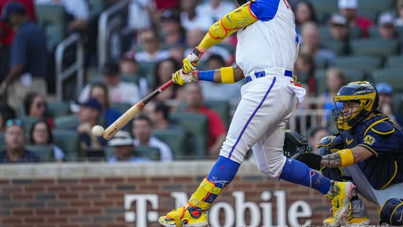 Jul 29, 2023; Cumberland, Georgia, USA; Atlanta Braves right fielder Ronald Acuna Jr. (13) hits a single against the Milwaukee Brewers during the first inning at Truist Park. Mandatory Credit: Dale Zanine-USA TODAY Sports