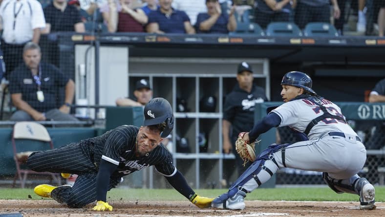 Jul 29, 2023; Chicago, Illinois, USA; Cleveland Guardians catcher Bo Naylor (23) tags out at home plate Chicago White Sox third baseman Yoan Moncada (10) during the fourth inning at Guaranteed Rate Field. Mandatory Credit: Kamil Krzaczynski-USA TODAY Sports