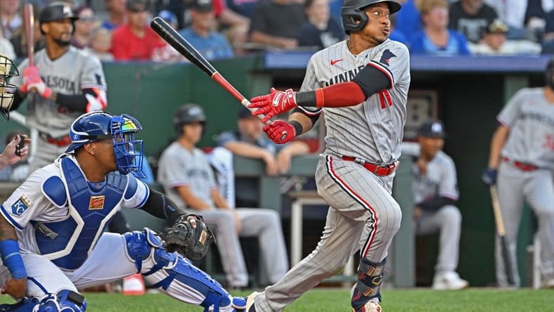 Jul 29, 2023; Kansas City, Missouri, USA; Minnesota Twins third baseman Jorge Polanco (11) drives in a run against the Kansas City Royals during the fourth inning at Kauffman Stadium. Mandatory Credit: Peter Aiken-USA TODAY Sports