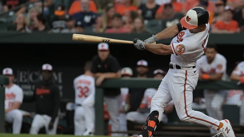 Jul 29, 2023; Baltimore, Maryland, USA; Baltimore Orioles second baseman Adam Frazier (12) doubles during the second inning against the New York Yankees at Oriole Park at Camden Yards. Mandatory Credit: Tommy Gilligan-USA TODAY Sports