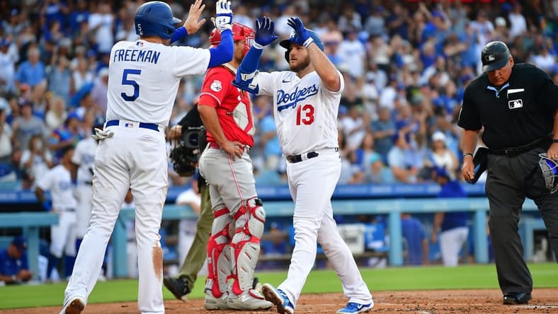 Jul 29, 2023; Los Angeles, California, USA; Los Angeles Dodgers third baseman Max Muncy (13) is greeted by first baseman Freddie Freeman (5) after hitting a two run home run against the Cincinnati Reds during the first inning at Dodger Stadium. Mandatory Credit: Gary A. Vasquez-USA TODAY Sports