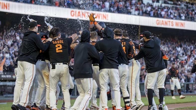 Jul 29, 2023; San Francisco, California, USA; San Francisco Giants third baseman J.D. Davis (7) celebrates with teammates after hitting a solo home run during the ninth inning to defeat the Boston Red Sox at Oracle Park. Mandatory Credit: John Hefti-USA TODAY Sports