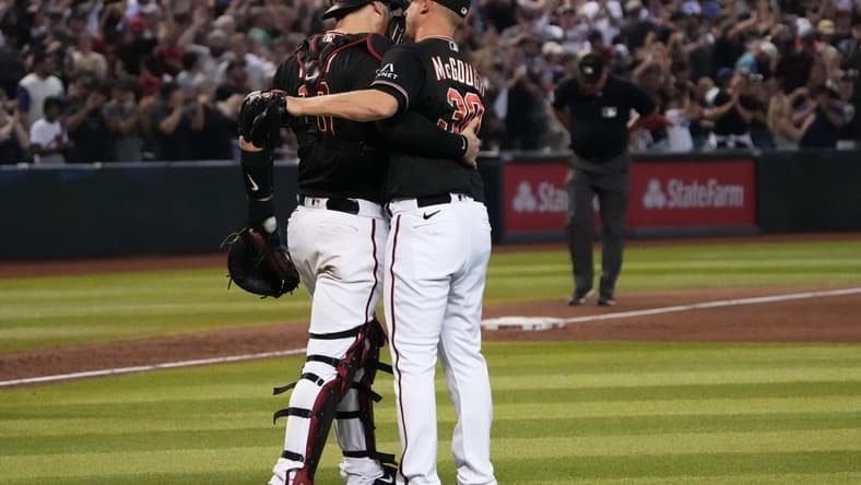 Jul 29, 2023; Phoenix, Arizona, USA; Arizona Diamondbacks catcher Carson Kelly (18) and Arizona Diamondbacks relief pitcher Scott McGough (30) celebrate after defeating the Seattle Mariners at Chase Field. Mandatory Credit: Joe Camporeale-USA TODAY Sports