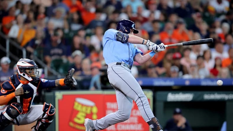 Jul 30, 2023; Houston, Texas, USA; Tampa Bay Rays left fielder Luke Raley (55) hits an RBI infield single against the Houston Astros during the first inning at Minute Maid Park. Mandatory Credit: Erik Williams-USA TODAY Sports