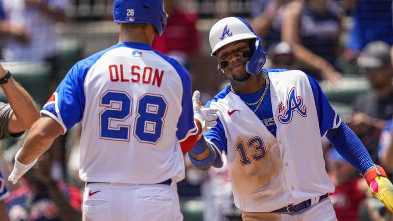 Jul 30, 2023; Cumberland, Georgia, USA; Atlanta Braves first baseman Matt Olson (28) reacts with right fielder Ronald Acuna Jr. (13) after hitting a three run home run against the Milwaukee Brewers during the third inning at Truist Park. Mandatory Credit: Dale Zanine-USA TODAY Sports