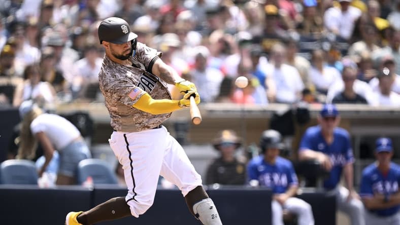 Jul 30, 2023; San Diego, California, USA; San Diego Padres catcher Gary Sanchez (99) hits a home run against the Texas Rangers during the fifth inning at Petco Park. Mandatory Credit: Orlando Ramirez-USA TODAY Sports