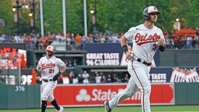 Jul 30, 2023; Baltimore, Maryland, USA; Baltimore Orioles first baseman Ryan O   Hearn (32) and outfielder Austin Hays (21) round the bases to score on outfielder Adam Frazier   s (not shown) three-run home run in the first inning against the New York Yankees at Oriole Park at Camden Yards. Mandatory Credit: Mitch Stringer-USA TODAY Sports
