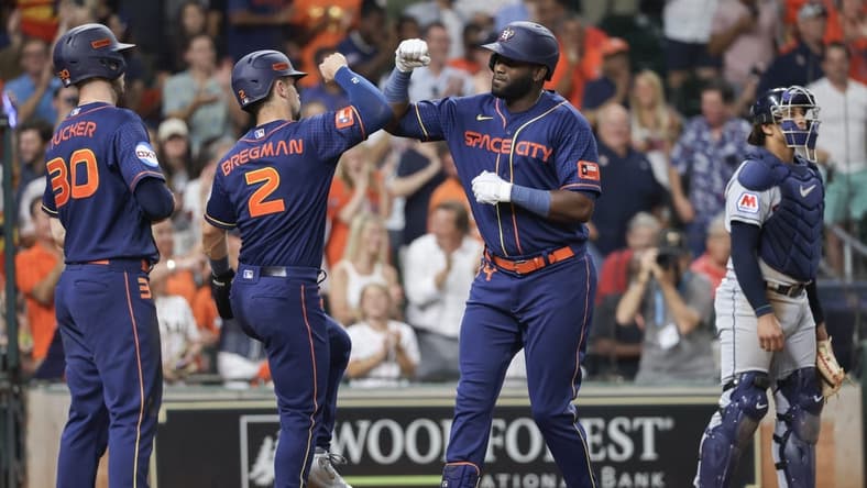 Jul 31, 2023; Houston, Texas, USA; Houston Astros left fielder Yordan Alvarez (44) celebrates his three-run home run with right fielder Kyle Tucker (30) and third baseman Alex Bregman (2) against the Cleveland Guardians in the sixth inning at Minute Maid Park. Mandatory Credit: Thomas Shea-USA TODAY Sports