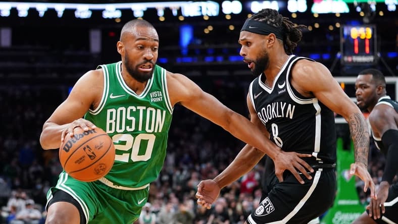 Nov 24, 2021; Boston, Massachusetts, USA; Boston Celtics forward Jabari Parker (20) drives the ball against Brooklyn Nets guard Patty Mills (8) in the second half at TD Garden. Mandatory Credit: David Butler II-USA TODAY Sports