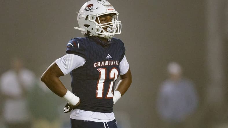 Chaminade-Madonna's Zaquan Patterson (12) walks off the field to meet with his team during a timeout. Chaminade-Madonna shutout Berkeley Prep 21-0 to claim the 3A State Championship title at Gene Cox Stadium on Friday, Dec. 10, 2021.

Second Half Chaminade Madonna V Bp 021