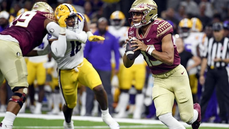 Sep 4, 2022; New Orleans, Louisiana, USA; Florida State Seminoles quarterback Jordan Travis (13) scrambles during the first half against the Louisiana State Tigers at Caesars Superdome. Mandatory Credit: Melina Myers-USA TODAY Sports