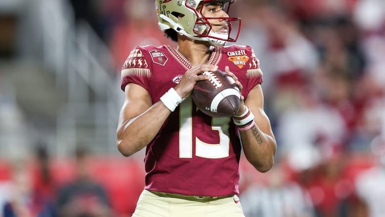 Dec 29, 2022; Orlando, Florida, USA; Florida State Seminoles quarterback Jordan Travis (13) drops back to pass against the Oklahoma Sooners in the second quarter during  the 2022 Cheez-It Bowl at Camping World Stadium. Mandatory Credit: Nathan Ray Seebeck-USA TODAY Sports