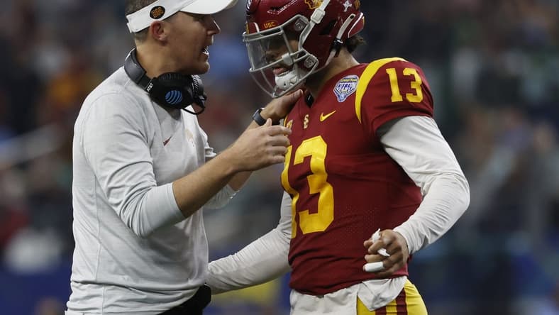 Jan 2, 2023; Arlington, Texas, USA; USC Trojans head coach Lincoln Riley talks to quarterback Caleb Williams (13) during the game against the Tulane Green Wave in the 2023 Cotton Bowl at AT&T Stadium. Mandatory Credit: Tim Heitman-USA TODAY Sports