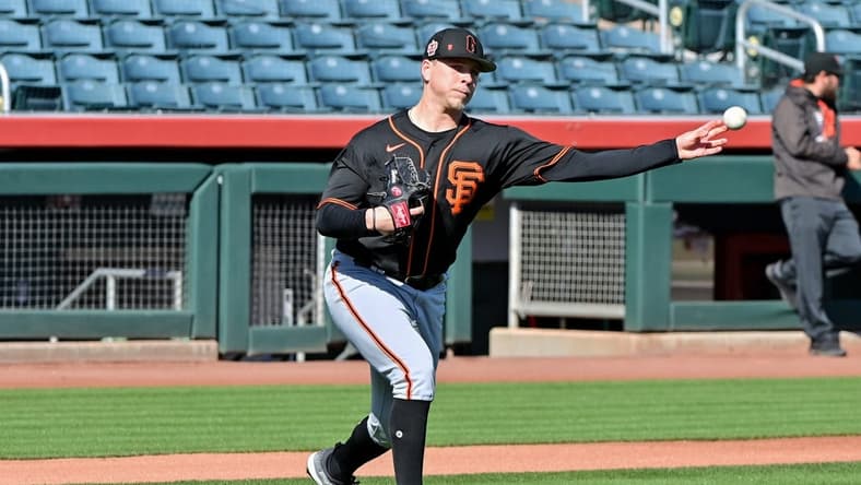 Feb 16, 2023; Scottsdale, AZ, USA; San Francisco Giants pitcher Kyle Harrison (86) throws to first base during a drill during a Spring Training workout at Scottsdale Stadium. Mandatory Credit: Matt Kartozian-USA TODAY Sports