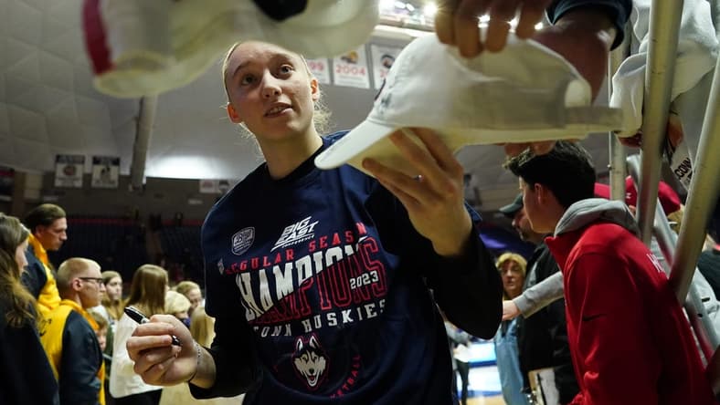 Feb 27, 2023; Storrs, Connecticut, USA; UConn Huskies guard Paige Bueckers (5) signs autographs after her teammates defeated the Xavier Musketeers at Harry A. Gampel Pavilion. Mandatory Credit: David Butler II-USA TODAY Sports