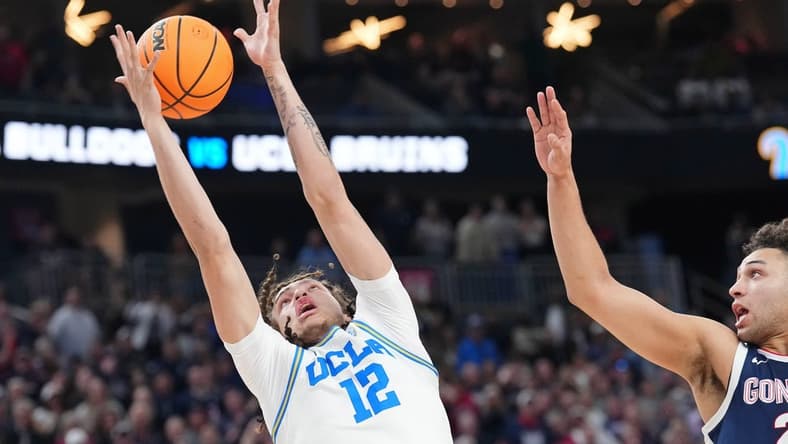 Mar 23, 2023; Las Vegas, NV, USA; UCLA Bruins forward Mac Etienne (12) reaches for the ball against Gonzaga Bulldogs forward Anton Watson (22) during the second half at T-Mobile Arena. Mandatory Credit: Joe Camporeale-USA TODAY Sports