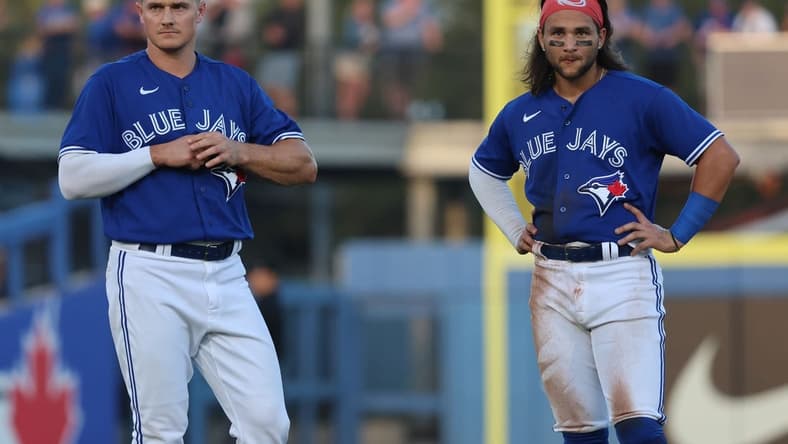 Mar 25, 2023; Dunedin, Florida, USA; Toronto Blue Jays third baseman Matt Chapman (26) and shortstop Bo Bichette (11) look on against the Detroit Tigers  at TD Ballpark. Mandatory Credit: Kim Klement-USA TODAY Sports