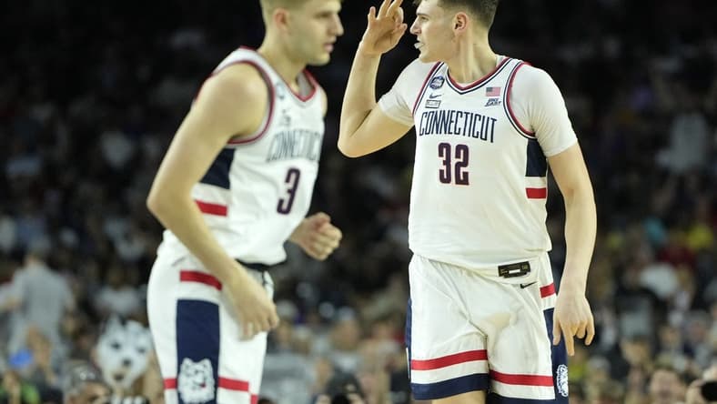 Apr 3, 2023; Houston, TX, USA; Connecticut Huskies center Donovan Clingan (32) reacts after a play against the San Diego State Aztecs during the first half in the national championship game of the 2023 NCAA Tournament at NRG Stadium. Mandatory Credit: Bob Donnan-USA TODAY Sports