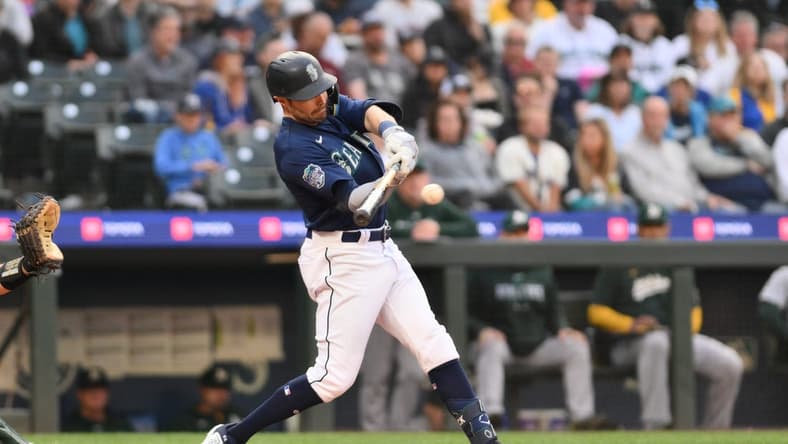 May 24, 2023; Seattle, Washington, USA; Seattle Mariners left fielder AJ Pollock (8) hits a single against the Oakland Athletics during the fourth inning at T-Mobile Park. Mandatory Credit: Steven Bisig-USA TODAY Sports