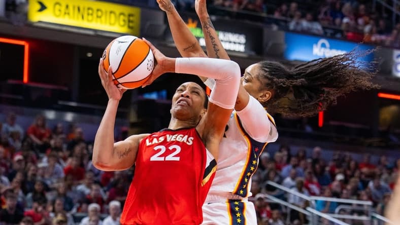 Jun 4, 2023; Indianapolis, Indiana, USA; Las Vegas Aces forward A'ja Wilson (22) shoots the ball while Indiana Fever guard Victoria Vivians (35) defends in the second half at Gainbridge Fieldhouse. Mandatory Credit: Trevor Ruszkowski-USA TODAY Sports